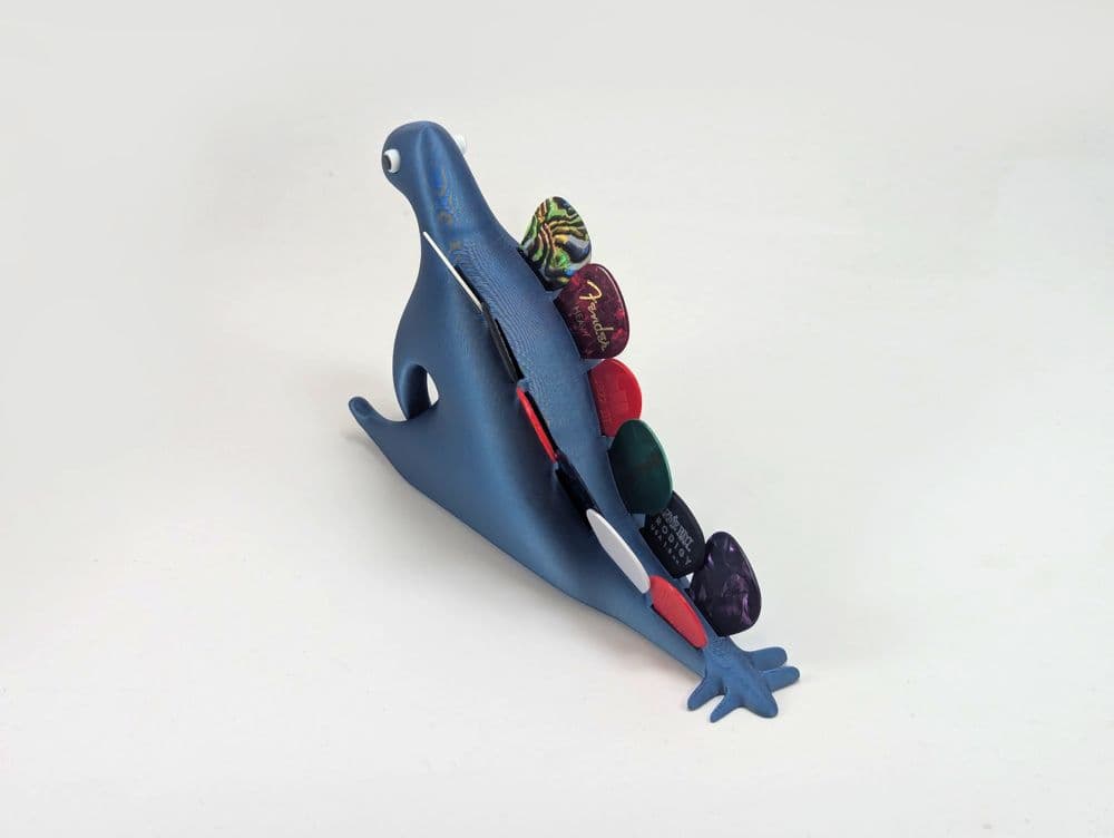 Porta-palhetas Dinossauro vista frontal mostrando o encaixe das palhetas